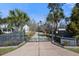 Gated driveway entrance surrounded by palm trees, ensuring privacy and leading to a beautiful property at 144 Clark Ln, Summerville, SC 29483
