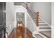 Elegant foyer featuring hardwood floors, a staircase with wood and wrought iron, and views into adjacent rooms at 144 Clark Ln, Summerville, SC 29483