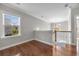 Upstairs hallway featuring hardwood floors, iron railing, and view of a chandelier at 144 Clark Ln, Summerville, SC 29483