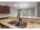 Kitchen bar featuring granite countertop, stainless steel sink, and bronze faucet at 144 Clark Ln, Summerville, SC 29483