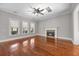 Bright living room featuring hardwood floors, fireplace, and large windows with natural light at 144 Clark Ln, Summerville, SC 29483