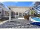Backyard featuring a pergola-covered bar, pool, and white rock landscaping at 144 Clark Ln, Summerville, SC 29483