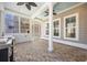 Enclosed sunroom with brick flooring, ceiling fans and ample natural light at 144 Clark Ln, Summerville, SC 29483