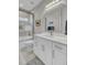 Bright bathroom featuring dual vanity, framed mirror and a shower-over-tub with glass door at 1523 Star Flower Aly, Johns Island, SC 29455