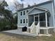 Backyard view featuring a house with a screened-in porch and a stone patio at 1601 Secessionville Rd, Charleston, SC 29412