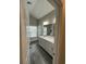 Bathroom view featuring double vanity, neutral walls, gray tile, large mirror, and a separate toilet at 1601 Secessionville Rd, Charleston, SC 29412