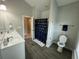 Bright bathroom featuring a double vanity, tile floors, and a tub-shower with stylish pineapple curtains at 1601 Secessionville Rd, Charleston, SC 29412