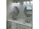Bathroom featuring a double sink vanity with chrome fixtures, decorative mirrors and modern lighting at 1601 Secessionville Rd, Charleston, SC 29412