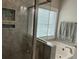 Bright bathroom with a glass enclosed shower, soaking tub, and a large window at 1601 Secessionville Rd, Charleston, SC 29412