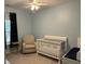 Cozy Bedroom with crib, glider, and soft blue walls at 1601 Secessionville Rd, Charleston, SC 29412