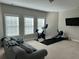Spacious bonus room featuring home gym equipment, a comfortable couch, and natural light at 1601 Secessionville Rd, Charleston, SC 29412