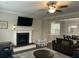 Bright living room with fireplace, modern ceiling fan, and view into dining area at 1601 Secessionville Rd, Charleston, SC 29412