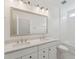 Bright bathroom showcasing a dual sink vanity, a large mirror, and a tiled bathtub at 1738 Cultivation Ln # 532, Mount Pleasant, SC 29466