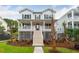 Inviting two-story home featuring a charming porch, lush landscaping, and classic architectural design at 1738 Cultivation Ln # 532, Mount Pleasant, SC 29466