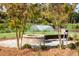 Outdoor fire pit with built in seating and water feature in background at 1738 Cultivation Ln # 532, Mount Pleasant, SC 29466