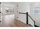 Hallway view of hardwood floors, white trim and views into open, light filled rooms at 1738 Cultivation Ln # 532, Mount Pleasant, SC 29466