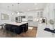 Bright, modern kitchen featuring stainless steel appliances, a large island with seating, and a farmhouse sink at 1738 Cultivation Ln # 532, Mount Pleasant, SC 29466