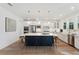 Modern kitchen features stainless steel appliances, a large island with seating, and a farmhouse sink at 1738 Cultivation Ln # 532, Mount Pleasant, SC 29466
