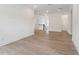 Open floor plan with wood floors, white walls, and staircase with black handrail at 1738 Cultivation Ln # 532, Mount Pleasant, SC 29466
