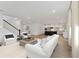 Open-concept living room showcasing hardwood floors, a staircase, and views into the modern, eat-in kitchen at 1738 Cultivation Ln # 532, Mount Pleasant, SC 29466