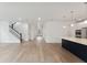 Open-concept living space featuring hardwood floors, a staircase, and a modern kitchen at 1738 Cultivation Ln # 532, Mount Pleasant, SC 29466