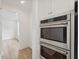 New, stainless steel oven/microwave combo set into white kitchen cabinetry, located near the dining room at 1738 Cultivation Ln # 532, Mount Pleasant, SC 29466