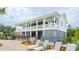 Exterior view of a two story pool house with lounge chairs by the pool at 1738 Cultivation Ln # 532, Mount Pleasant, SC 29466