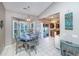 Sun-drenched breakfast nook offering views of the backyard, a slider to the patio, and barstool seating at 1908 Oak Tree Ln, Mount Pleasant, SC 29464