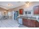 A kitchen with wooden cabinets, granite counters, stainless steel appliances, and a dining area at 1908 Oak Tree Ln, Mount Pleasant, SC 29464