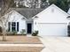 Charming one-story home with a well-manicured lawn, black front door and a two-car garage at 2117 Colson Ln, Johns Island, SC 29455