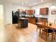 Well-equipped kitchen with modern appliances, kitchen island, adjacent dining area, and hardwood flooring at 2117 Colson Ln, Johns Island, SC 29455
