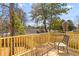 Relaxing outdoor deck with wooden railing and a comfortable chair and table setting at 2193 Helm Ave, North Charleston, SC 29405