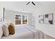Bright bedroom featuring large window, ceiling fan, and stylish decorative wall art at 2193 Helm Ave, North Charleston, SC 29405