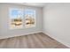 Bright empty bedroom with hardwood flooring and a view from the window at 2193 Helm Ave, North Charleston, SC 29405