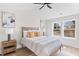 Sunlit bedroom with a neutral color palette, ceiling fan, wood floors, and large windows providing beautiful outside views at 2193 Helm Ave, North Charleston, SC 29405