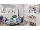 Chic dining area has a glass table, stylish chairs, and an open view to the kitchen and living spaces at 2193 Helm Ave, North Charleston, SC 29405
