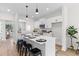 Modern kitchen with white cabinets, stainless steel appliances, and an island with seating, blending style with functionality at 2193 Helm Ave, North Charleston, SC 29405