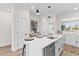 Modern kitchen island with white countertops, seating, and stylish fixtures, ideal for casual dining and entertaining at 2193 Helm Ave, North Charleston, SC 29405