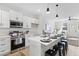 Well-lit kitchen with white cabinetry, stainless steel appliances, and a view into the living area, creating an inviting space at 2193 Helm Ave, North Charleston, SC 29405