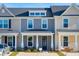 New townhomes with manicured front lawns and welcoming front porches at 231 Abercom Place Dr, Moncks Corner, SC 29461