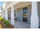 Exterior of a home with a covered porch, white columns, and neat landscaping at 231 Abercom Place Dr, Moncks Corner, SC 29461