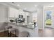 Stylish kitchen with a gray granite countertop island with seating, modern appliances, and a view to the front door at 231 Abercom Place Dr, Moncks Corner, SC 29461