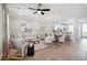 Open-concept living space featuring hardwood floors, contemporary furnishings, and a ceiling fan at 231 Abercom Place Dr, Moncks Corner, SC 29461