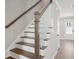 Staircase with wooden treads, white risers, and wooden handrail at 231 Abercom Place Dr, Moncks Corner, SC 29461