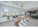 Bright dining room with high ceilings, large windows, a modern light fixture and an adjacent open kitchen at 245 Seven Farms Dr # 330, Charleston, SC 29492