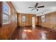 Cozy bedroom with hardwood floors, wood paneled walls and large windows, offering great natural light at 29 Nassau St, Charleston, SC 29403