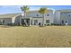 Spacious backyard features mature palm trees, screened patio, and room for entertaining at 310 Silent Bluff Dr, Summerville, SC 29486