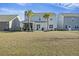 Spacious backyard features mature palm trees, screened patio, and room for entertaining at 310 Silent Bluff Dr, Summerville, SC 29486