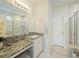 Well-lit bathroom with granite counters, double sinks, a large mirror, and a glass-enclosed shower at 310 Silent Bluff Dr, Summerville, SC 29486