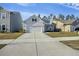 Charming two-story home features manicured lawn, attached garage, and inviting front porch at 310 Silent Bluff Dr, Summerville, SC 29486